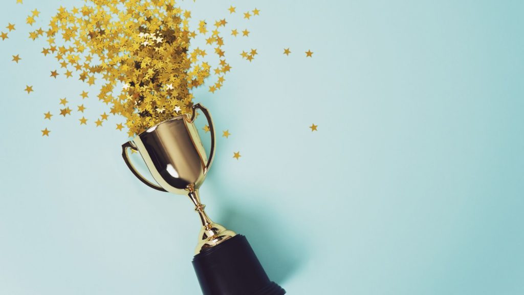 a trophy with confetti to show excitement around the announcement of the 2019 Video in Business Award winners